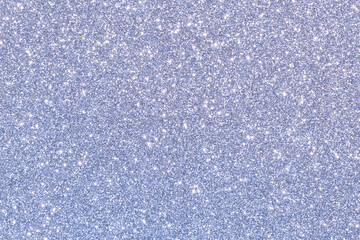 Obraz premium A blue and silver glittery background with a few small dots of color