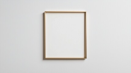 Blank picture frame hanging on a plain white wall. the frame is made of gold-colored wood and has a simple, rectangular shape with a thin gold border.