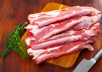Raw sliced beef steak served with sprig of dill to table