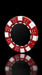 A red and white casino chip with dice patterns reflecting on a black surface, highlighting gambling.