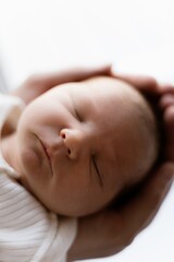 close up portrait of a little child on the parents hands