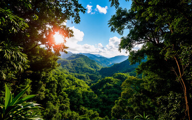 Obraz premium Verdant mountains extend to the horizon beneath a bright sky, beautifully framed by lush green trees. Sunlight filters through the dense foliage.