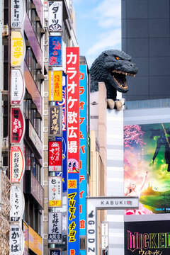 Japan, Tokyo - February 17, 2024: The iconic Godzilla head towers over Kabukicho in Shinjuku, Tokyo, surrounded by tall buildings and vibrant Japanese vertical signs.