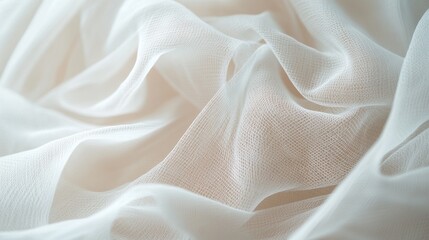 Obraz premium Elegant ivory net fabric with soft folds, creating an ethereal and delicate background texture perfect for bridal or luxury design.