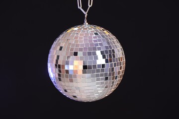 One shiny disco ball on black background