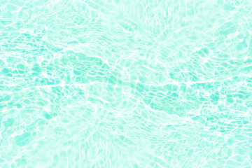 Blue water with ripples on the surface. Defocus blurred transparent blue colored clear calm water surface texture with splashes and bubbles. Water waves with shining pattern texture background.