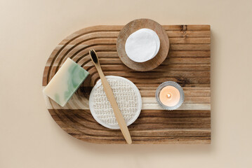 Top view of bathroom tools and organic cosmetic products on beige background emphasizing natural,...
