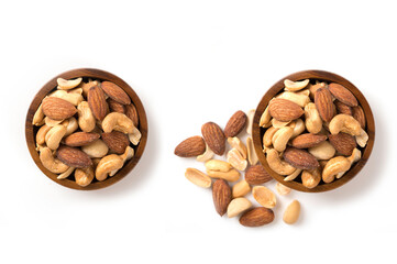 Mixed nuts in wooden bowl on a white isolated. top view