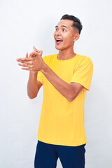 Joyful Asian man enthusiastically clapping hands, expressing cheerful excitement