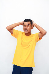 Man In Frustration: Expressing Overwhelm and Head Pain Against White Backdrop