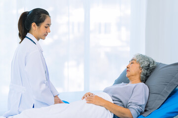 Fototapeta premium Asian female doctor consulting elderly patient at home, explaining diagnosis and treatment plan, providing health care to elderly woman, medical health concept