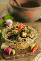 Stir-fried long beans mixed with tempeh in bowl. Tumis kacang panjang campur tempe. Indonesian traditional cuisine. Selective focus.