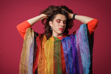 genderless person posing in support of Pride Month, teasing and wearing Pride colors