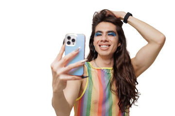 Genderqueer person takes a selfie wearing pride clothing, smiling and posing happily for the camera.