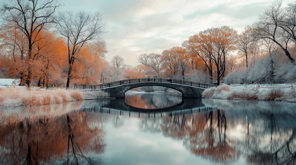 Stone bridge reflecting in calm water during snowy autumn in central park
