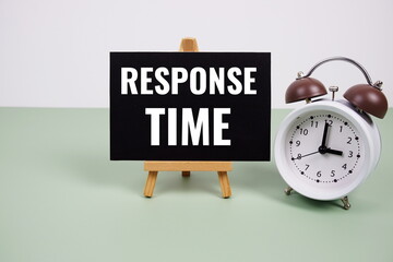 Response Time text on paper card with alarm clock on green background