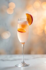 Sparkling Peach Cocktail in Glass with Slices and Bokeh