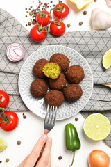 Falafel in a plate, on a light background.