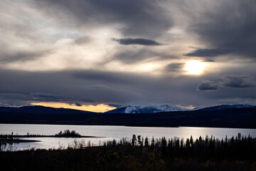 Colorful orange strip in the sky next to a mountain in Canada