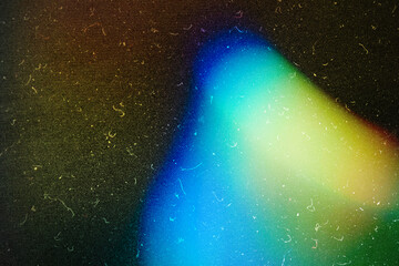 grainy colorful warm blue light leaks on black background with dust texture abstract damaged scratched retro film analog effect for using over photos as overlay or screen filter
