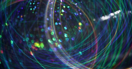 Holiday shining. Defocused futuristic flare. Multicolor bright gleaming particles lens glow motion...