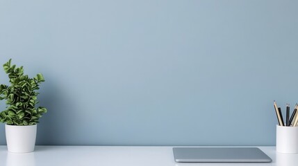 Minimalist interior design open space mindfulness. Minimalist workspace featuring a plant, tablet, and stationary on a light background.