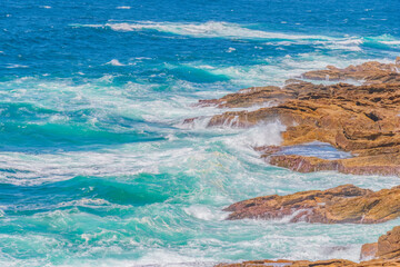 Afternoon sea breeze with choppy seas and earthy rocky headland