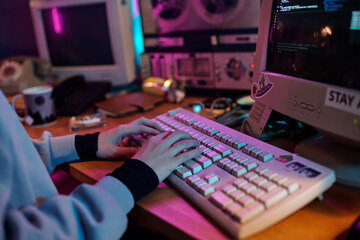 Hands Writing Code on Retro Computer