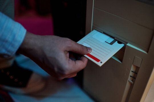 Unrecognizable Man Inserting Floppy Disk