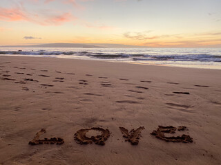 The word LOVE written in the sand on the tropical beaches of Makena, Maui, Hawaii