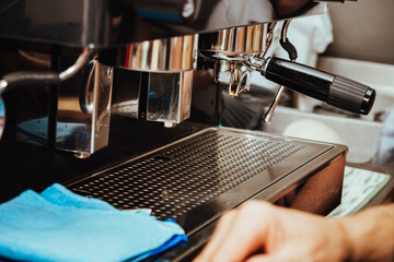 photo of espresso machine, with Colombian cups on it, lancet for texturizing the milk and cleaning...
