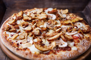 Gyros Pizza with with champignons and mozzarella cheese. Wooden background. Soft focus.	