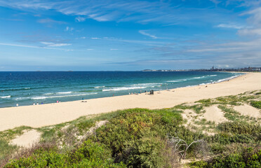 A view of City Beach in Wollongong, New South Wales, Australia, looking south towards the industrial Port Kembla area