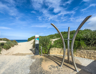 A view of City Beach in Wollongong, New South Wales, Australia looking at a beach shower used to remove sand from sand and saltwater from swimmers