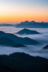 mountains covered in fog at sunset with a few clouds