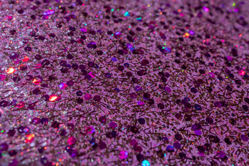 Full frame macro abstract texture background of sparkling multicolor pink glitter with copy space