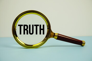 Truth text with magnifying on blue background