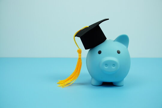 Piggy bank with graduate black cap Education and financial concept