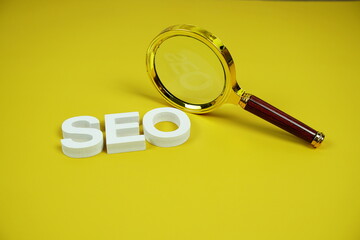 SEO alphabet letter with magnifying glass on yellow background