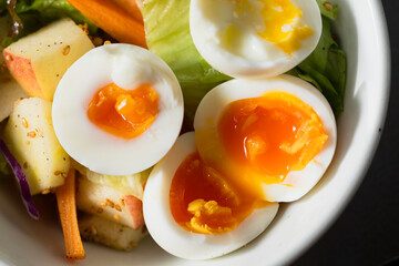 Boiled eggs with vegetables closeup
