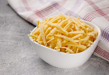 Heap of grated delicious cheese. Concept: Italian cuisine, cheese, restaurant, and food.