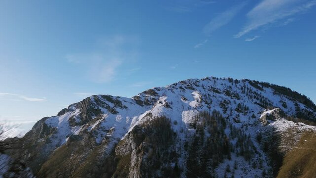 Mount Porta di Prada, rock arch, Grigne group, Lecco, Italy, snowy mountain landscape. Aerial forward, copy space