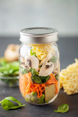 Healthy homemade instant noodles with vegetables in mason jar. Asian  vegetarian lunch idea