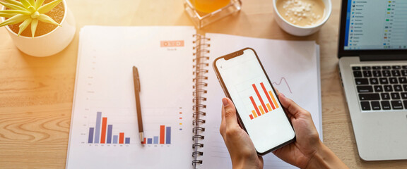 Tracking fat loss progress on phone in home office, health awareness