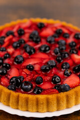 Fresh berry pie on a plate close-up. Berry pie close-up. Homemade cakes