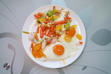 Scrambled eggs fried with vegetables on a white plate