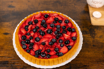 Fresh berry pie on a plate close-up. Berry pie close-up. Homemade cakes