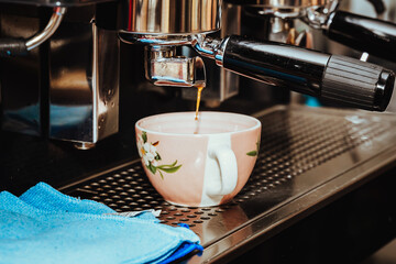 photo of the preparation of espresso coffee to make a cappuccino in an espresso coffee machine in a Colombian coffee house