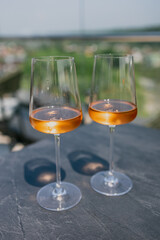 Two glasses of rose wine on a sunlit outdoor table