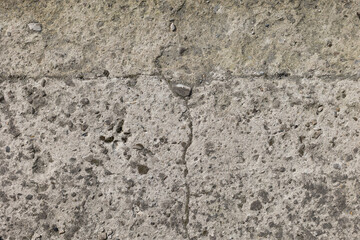 Background of destroyed concrete path, gray concrete, concrete texture, close-up. Natural photo. Old concrete slab